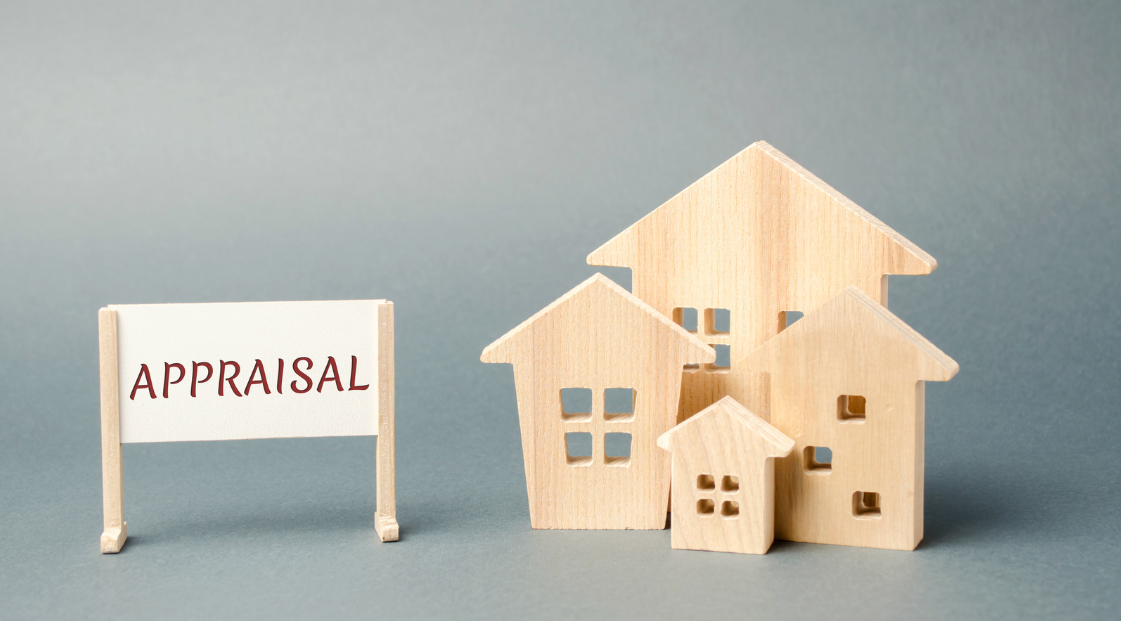 stock image of mini wooden houses with an appraisal sign for the home appraisal process